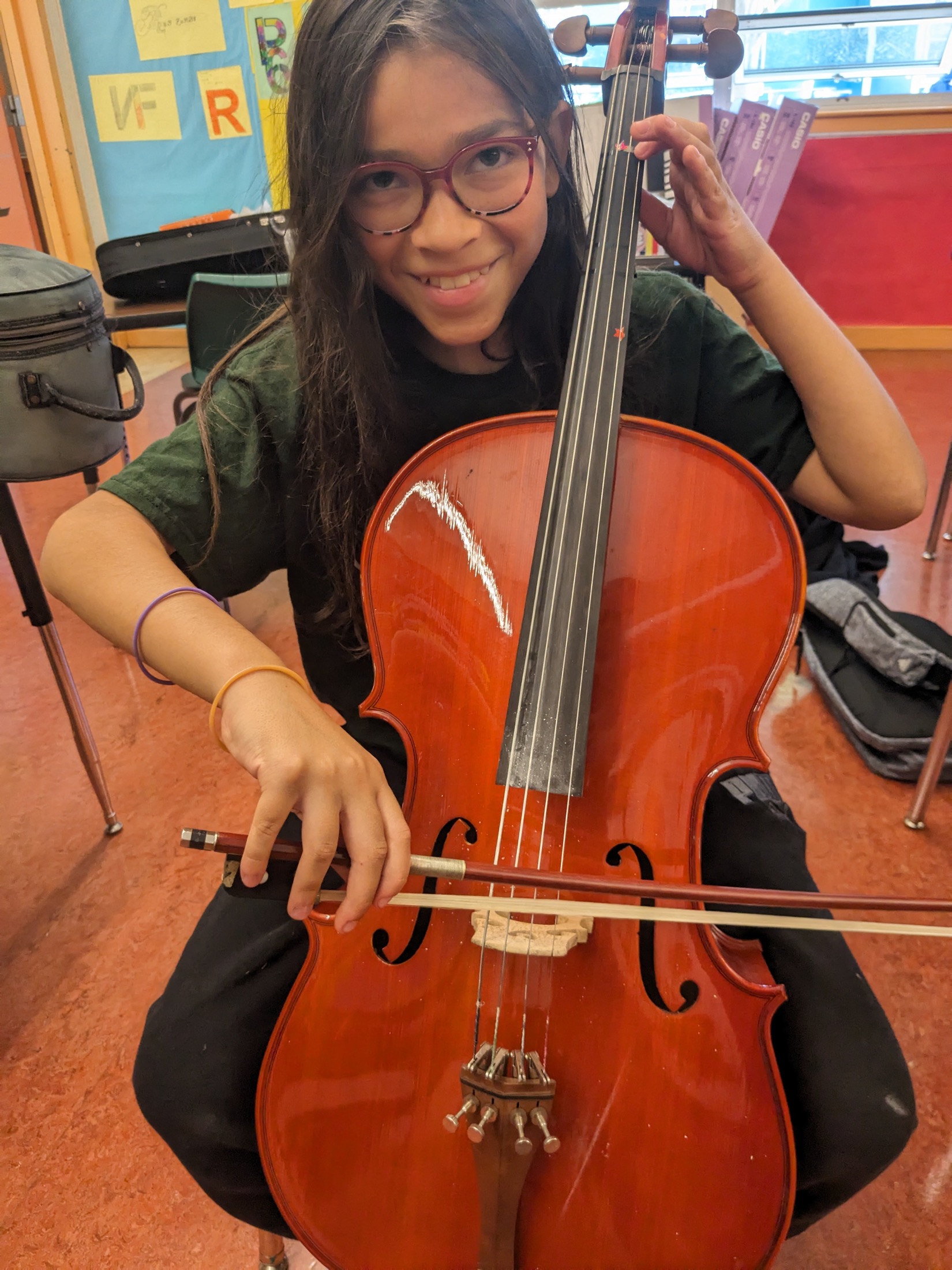 A student holding a cello in music class